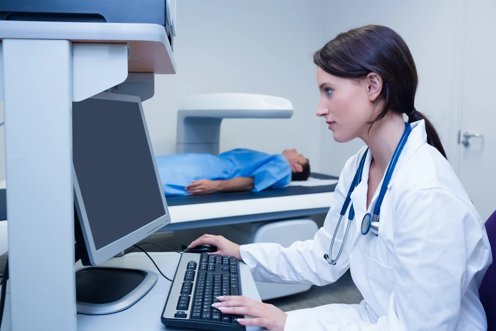 Clinician reviewing patient movement data on a computer.