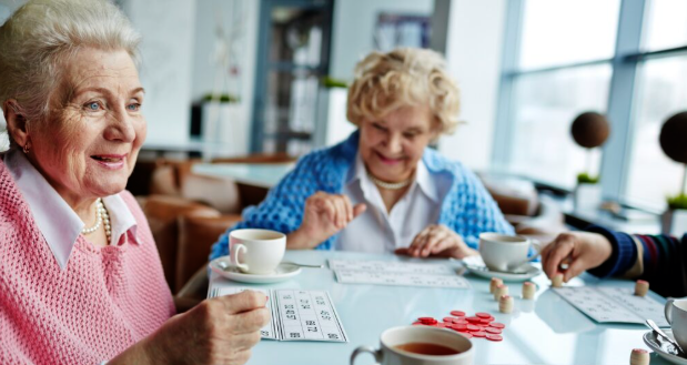 Older women staying active together at a table.